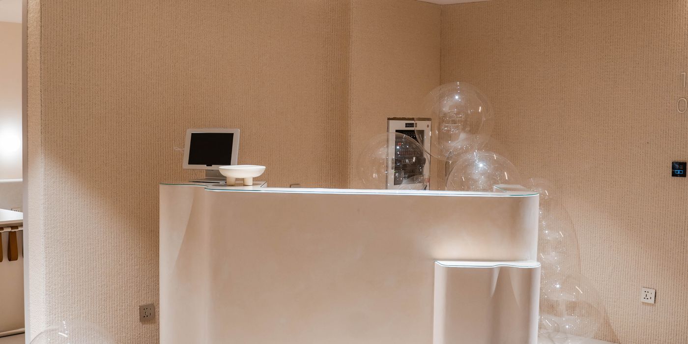 Modern minimalist hotel lobby with seating and reception