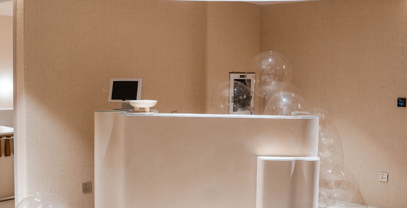 A modern hotel lobby with reception desk and minimalist decor