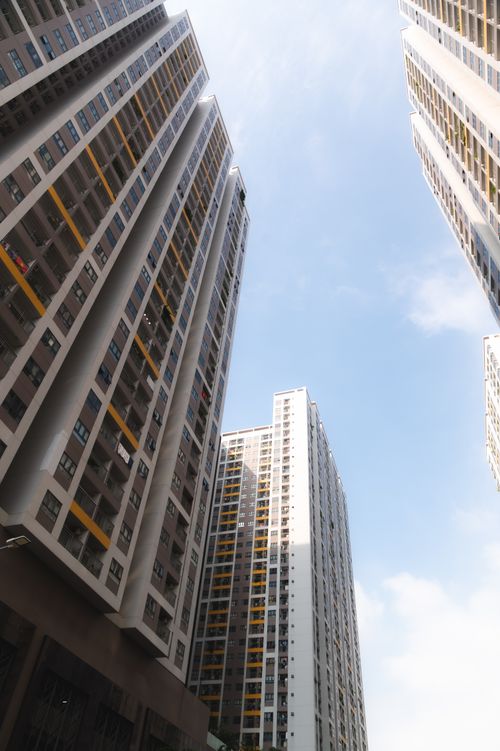 Free Striking view of tall apartment buildings reaching into a clear blue sky. Stock Photo