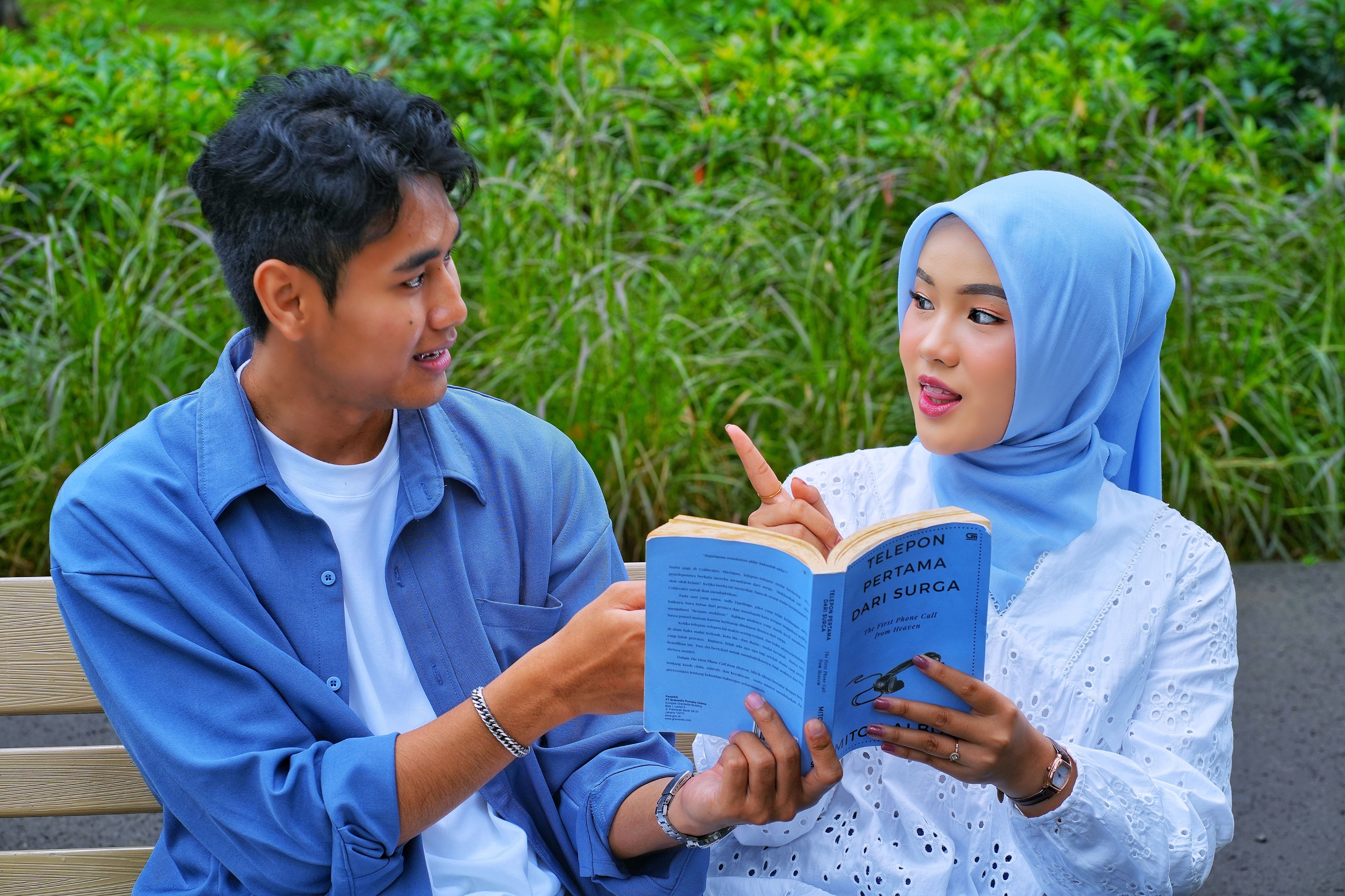Young Couple Engaging in Outdoor Reading Session