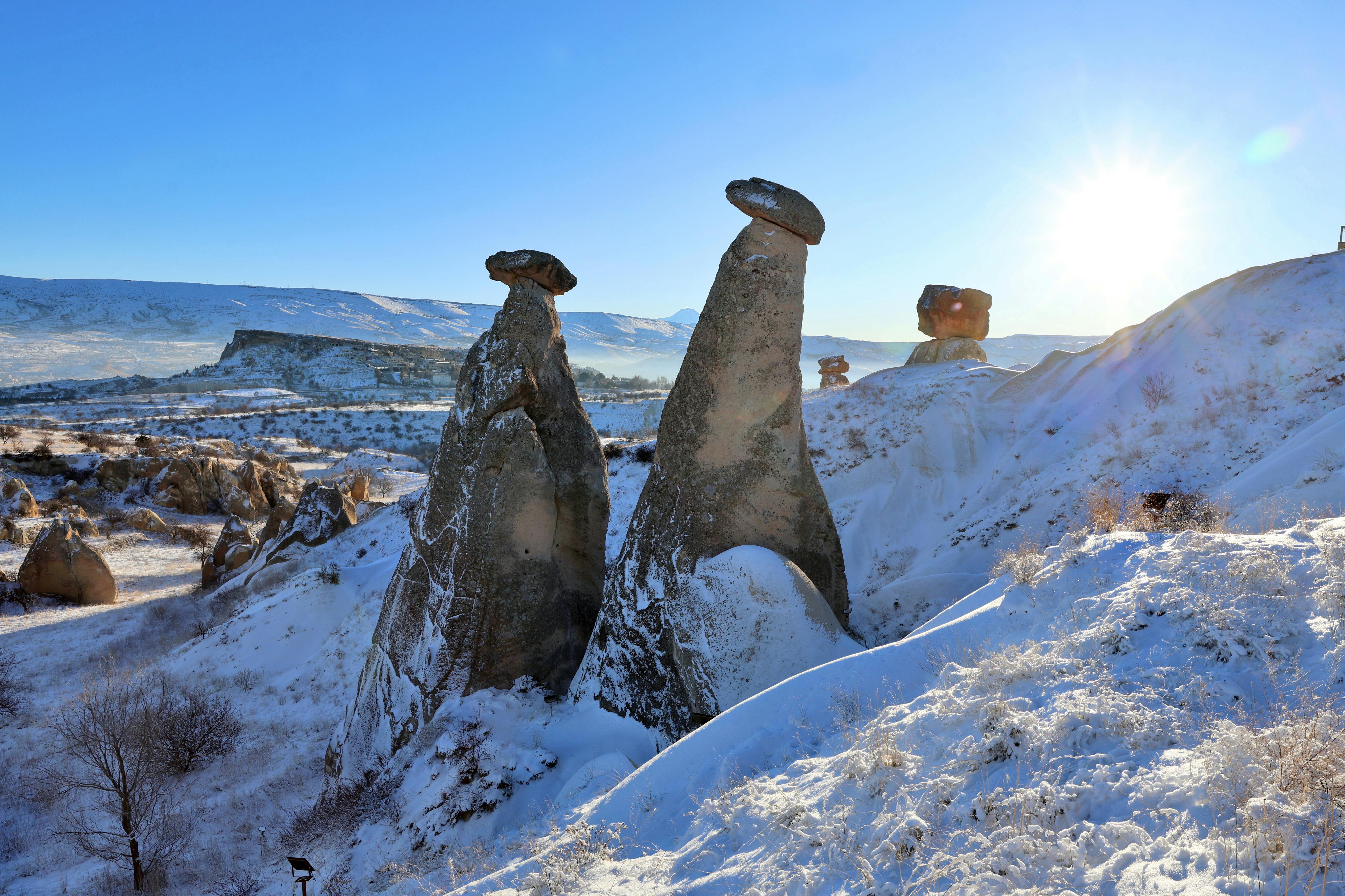 Stunning winter view of snow-covered fairy chimneys in Cappadocia, Turkey.