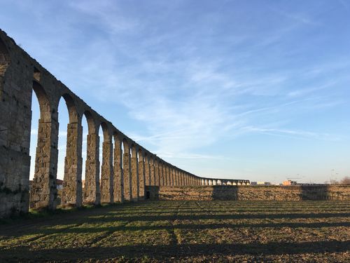 Free Long stone aqueduct under a clear blue sky in Vila do Conde, Portugal. Stock Photo