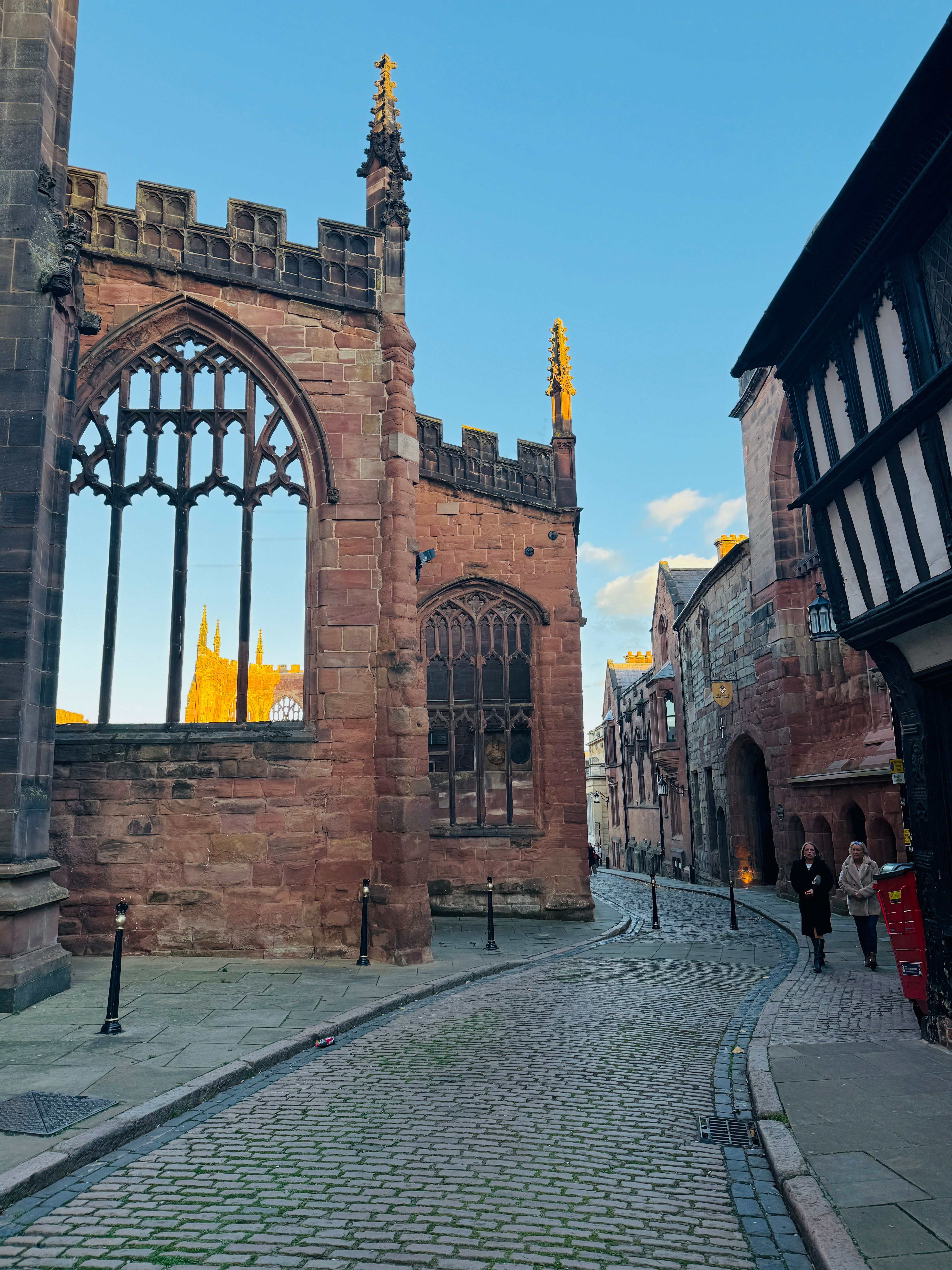 A cobbled street beside the ruins of the old Coventry Cathedral in the city centre
