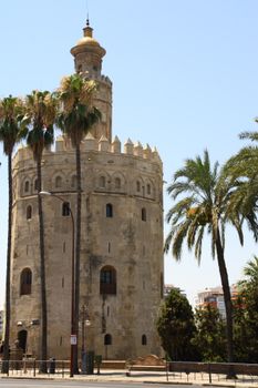 Torre del Oro under clear blue skies, Seville's iconic landmark.