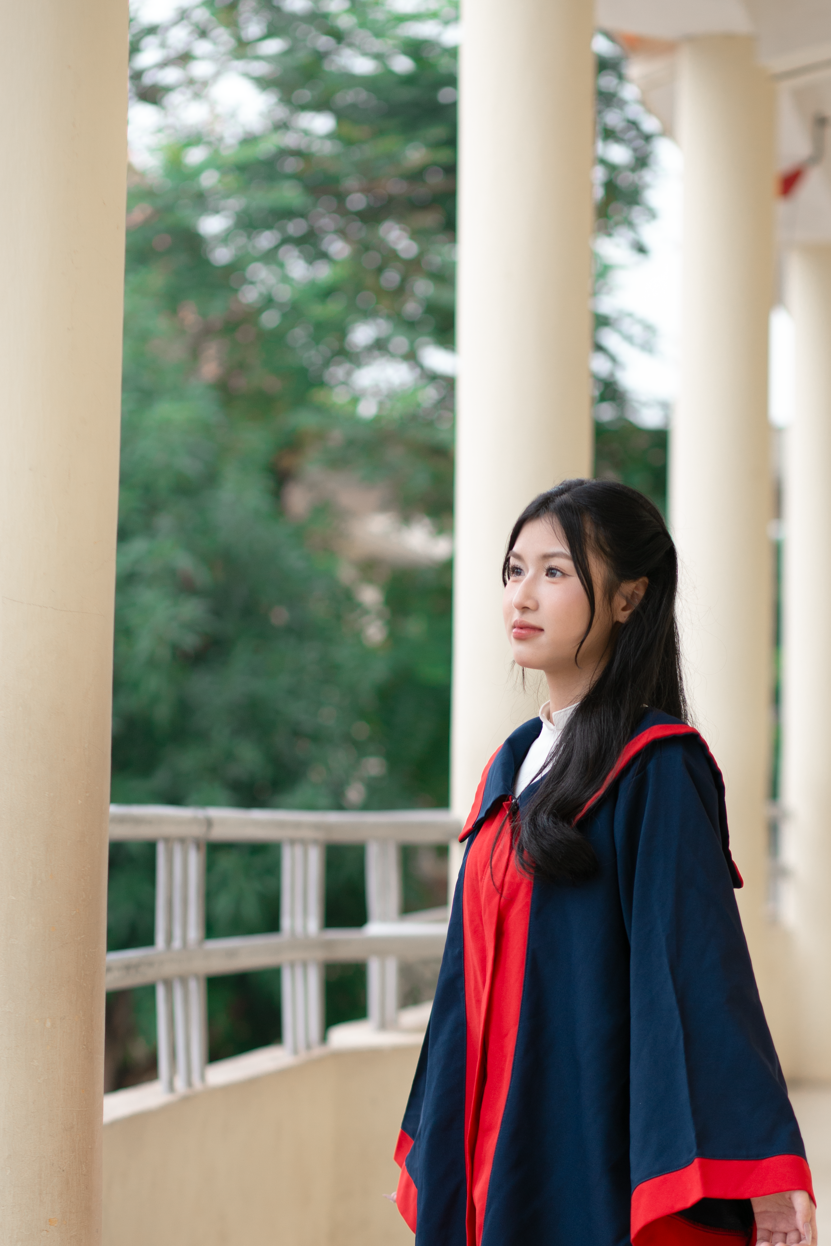 Young Graduate Posing Outdoors in Cap and Gown · Free Stock Photo