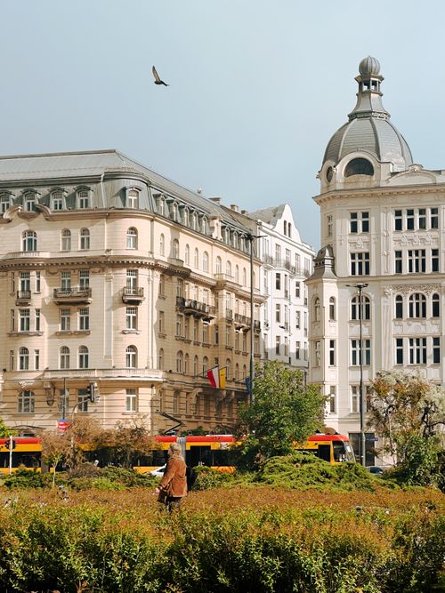 Free Elegant historic buildings with a garden in a European city center, showcasing classic architecture under a clear sky. Stock Photo