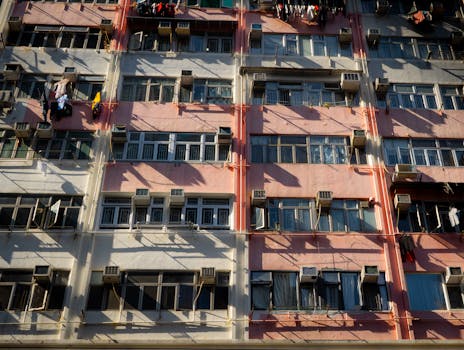 Close-up view of a vibrant apartment building facade with drying clothes in urban daylight.