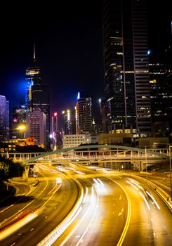 Vibrant cityscape at night showcasing dynamic light trails and skyscrapers.