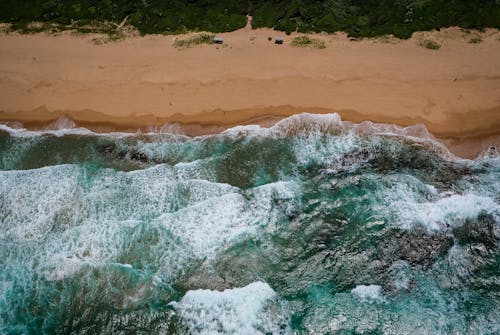 Aerial View Of Waves Rushing To Shore