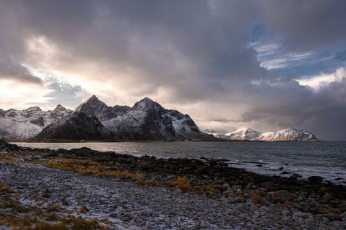 Free Picture of mountains and sea at Lofoten Islands, Norway, showcasing dramatic winter scenery. Stock Photo