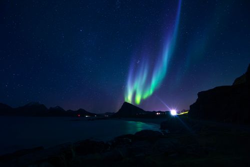 Free A breathtaking view of the Northern Lights illuminating the coast of Nordland, Norway. Stock Photo