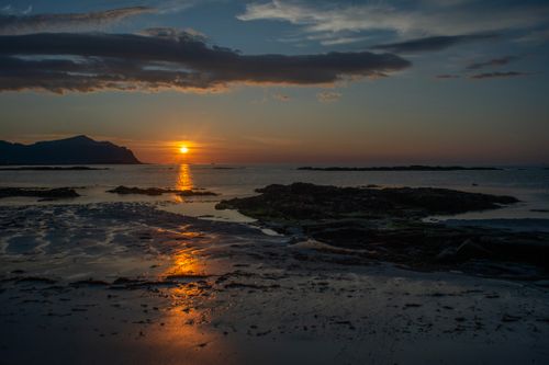 Free Stunning sunset over a serene beach in Nordland, Norge. Stock Photo