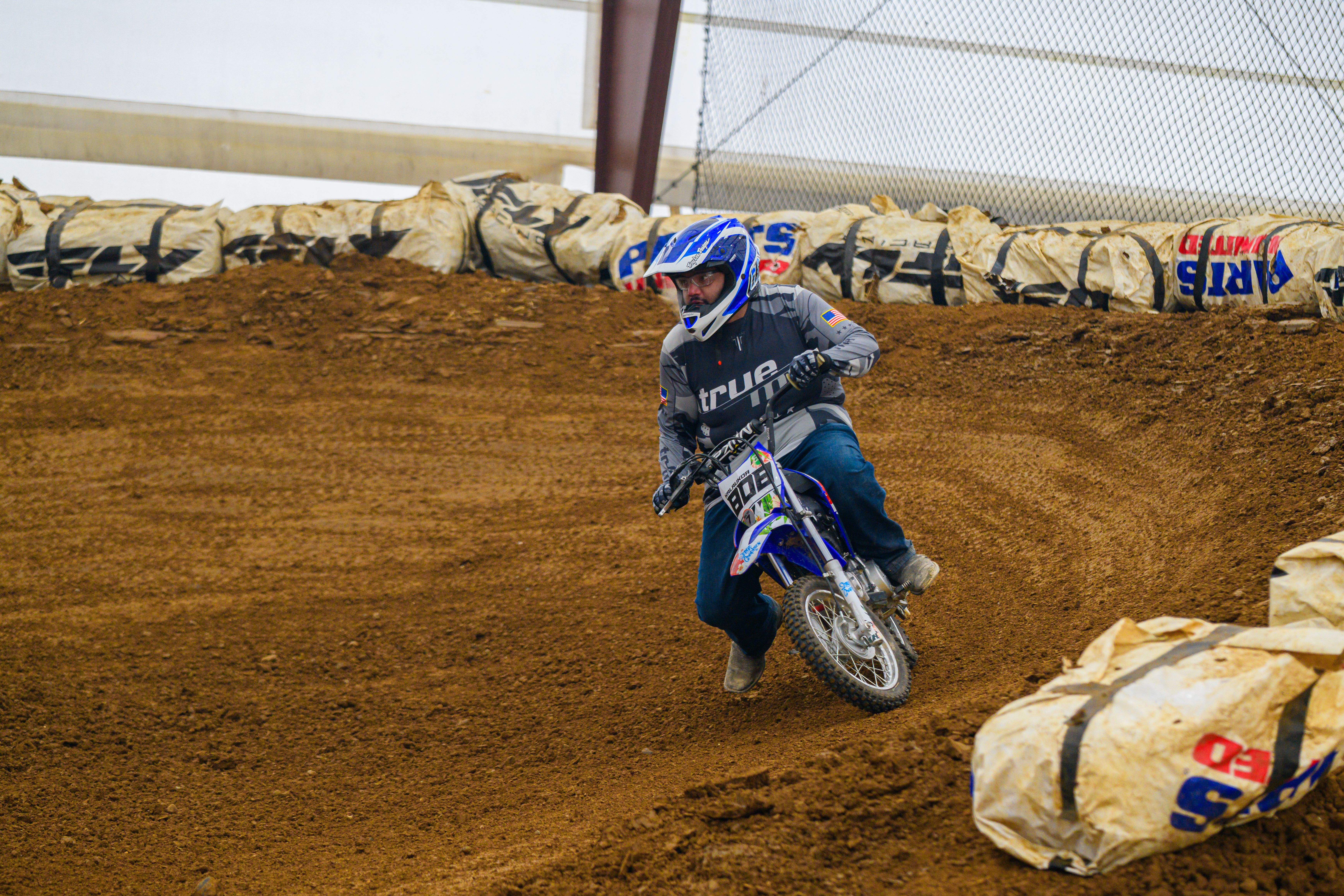 Exciting Indoor Off-Road Dirt Bike Race Action · Free Stock Photo