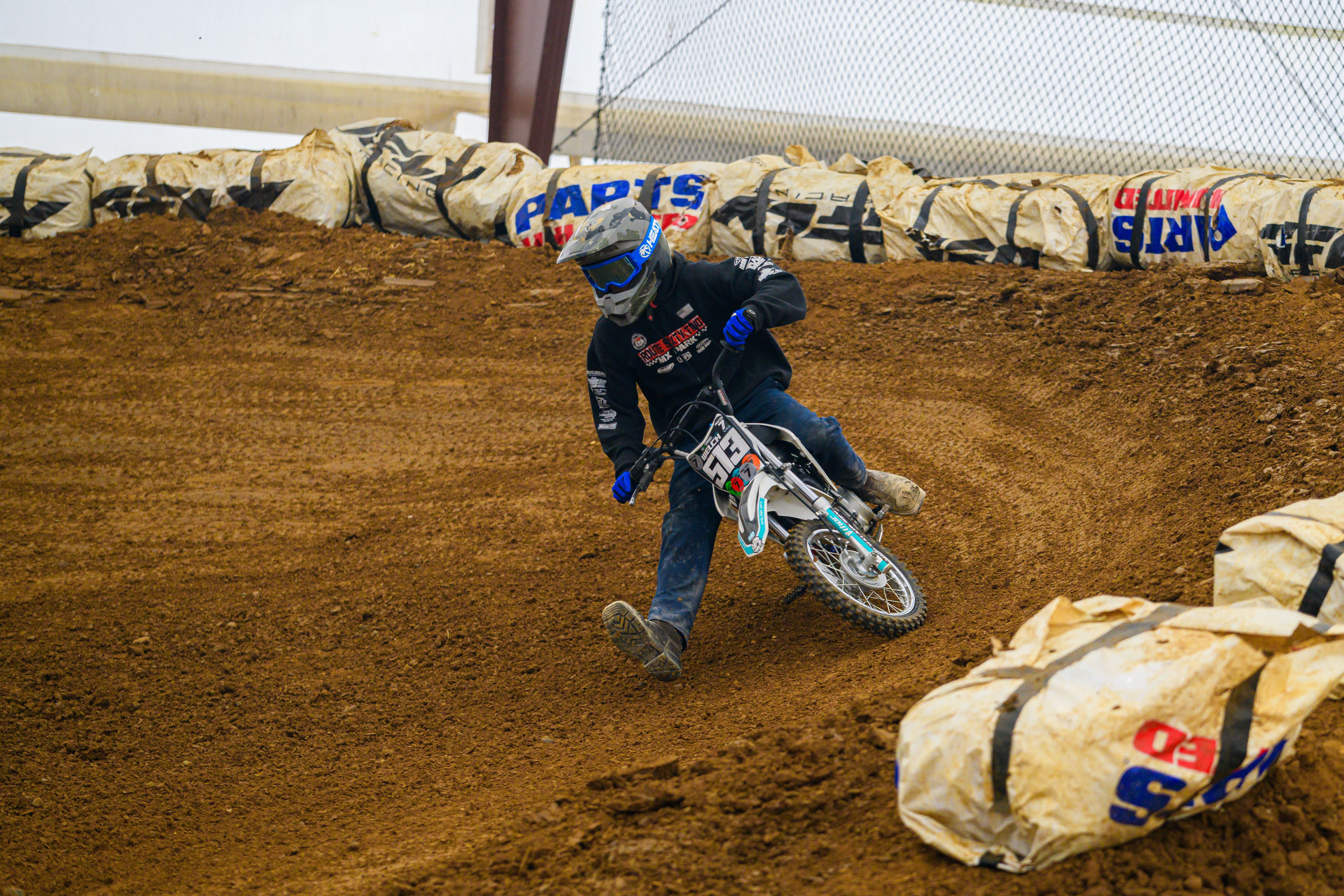Exciting off-road motorcycle racing scene featuring a rider navigating a dirt track.
