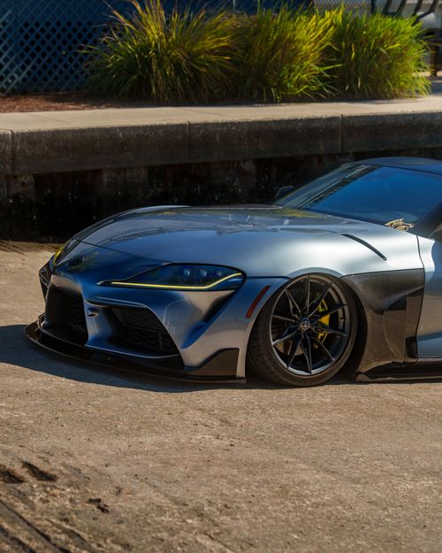 Free Sleek modern sports car parked on urban street on a sunny day. Stock Photo