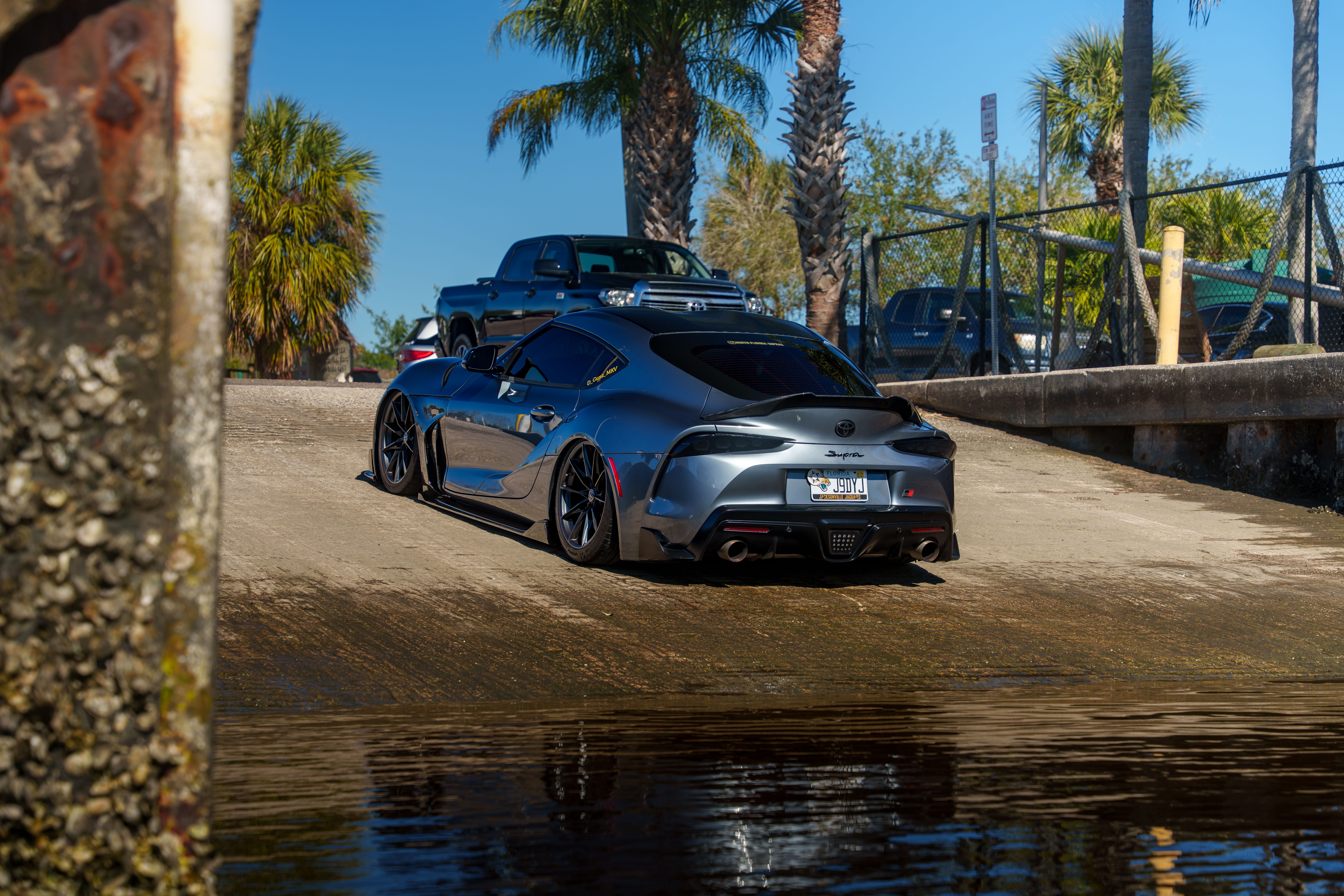 Sleek Car Near Waterfront on a Sunny Day · Free Stock Photo