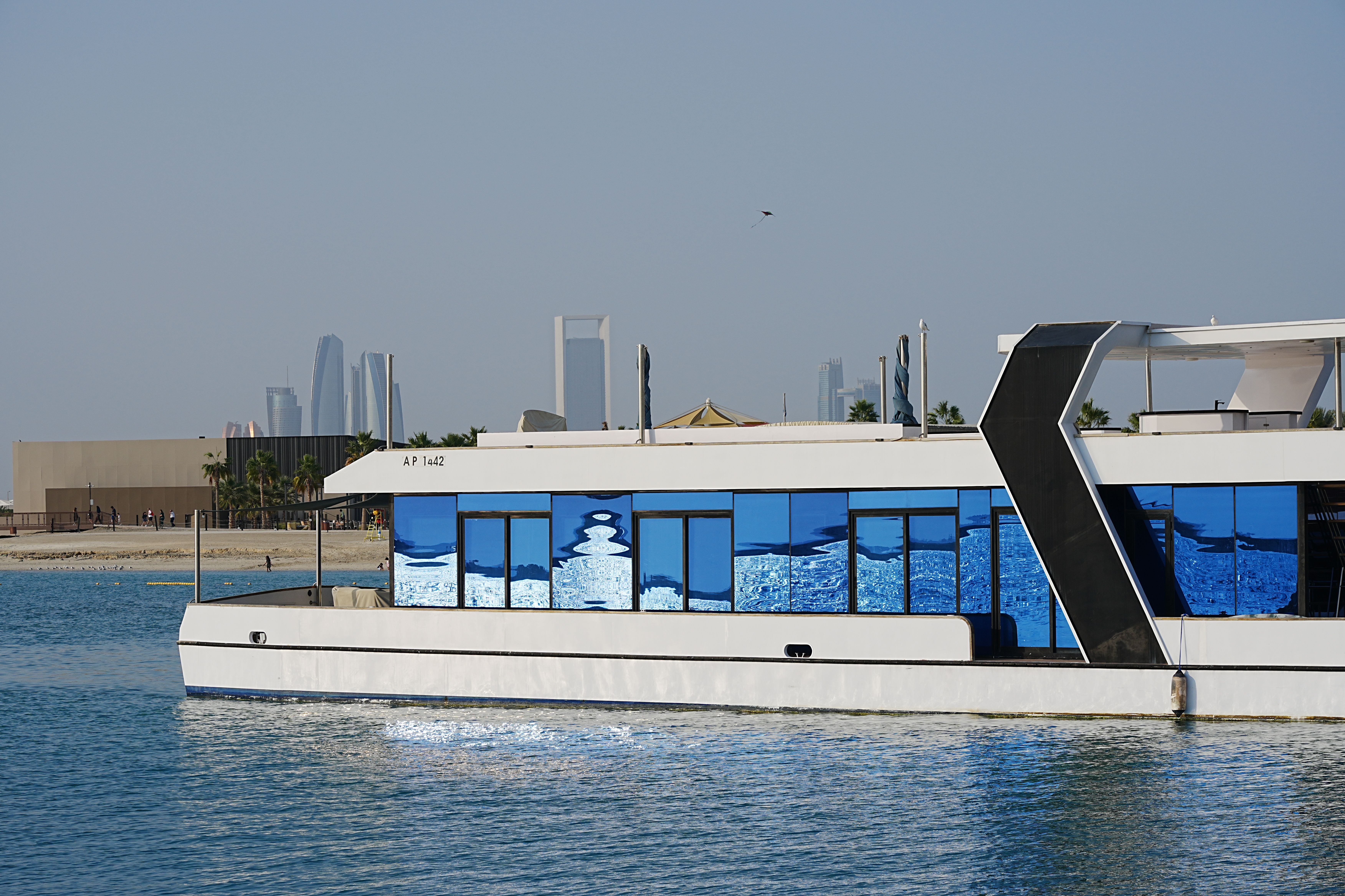 Contemporary yacht cruising on Dubai waters, framed by the iconic skyline and urban architecture.