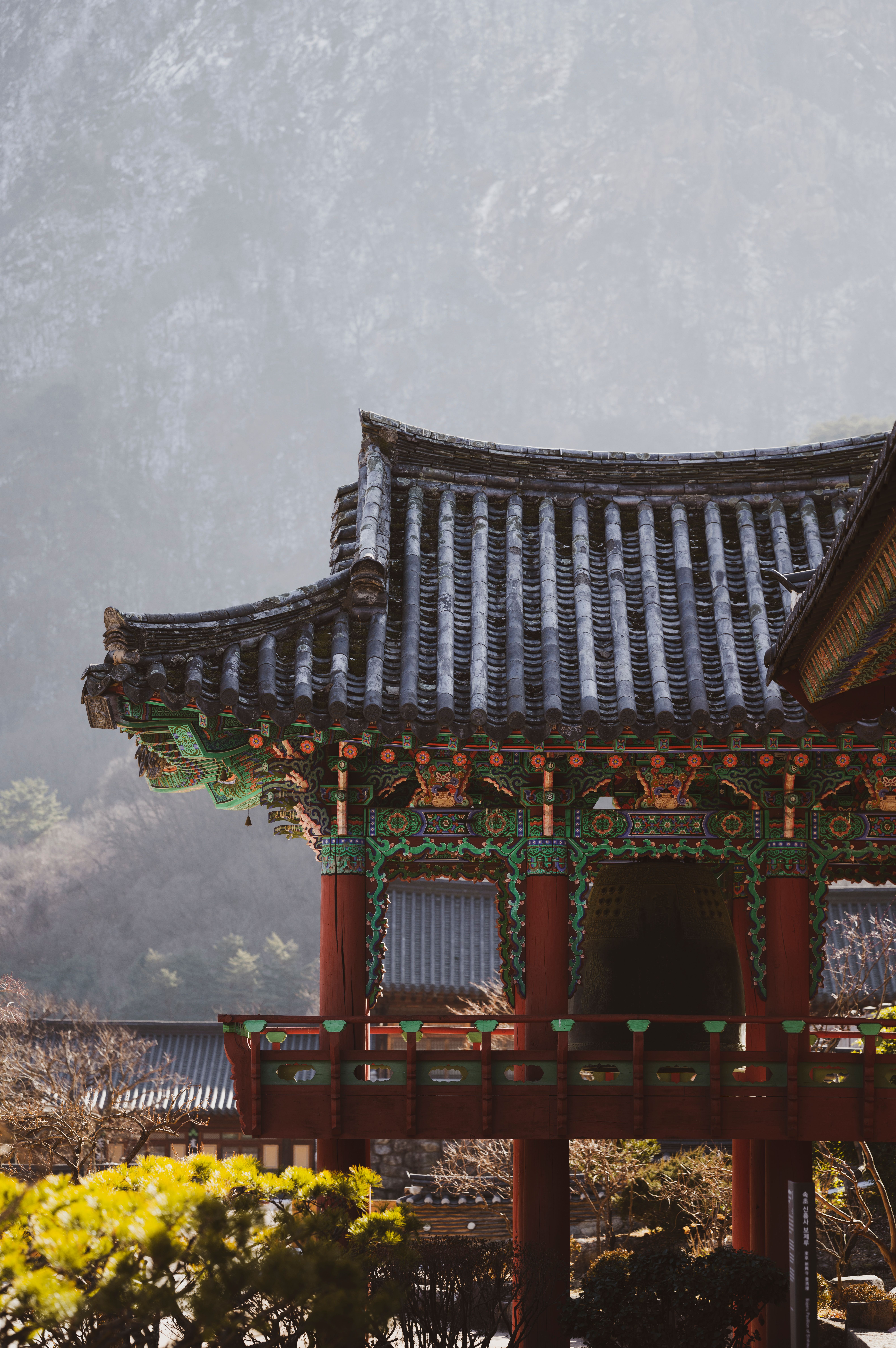 Peaceful scene of a traditional Korean temple in the mountains, showcasing intricate architecture.