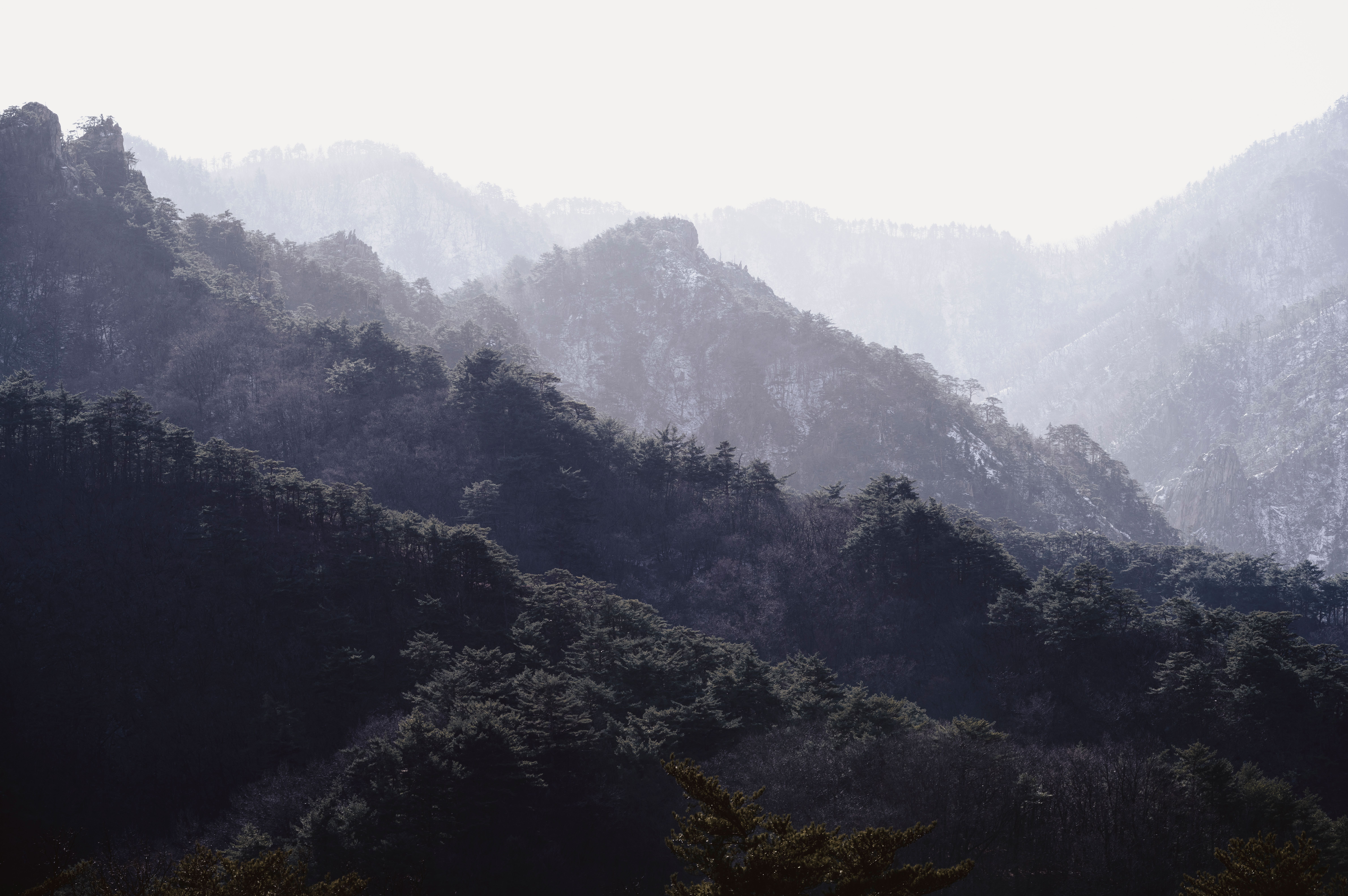 Misty mountain landscape with layered ridges