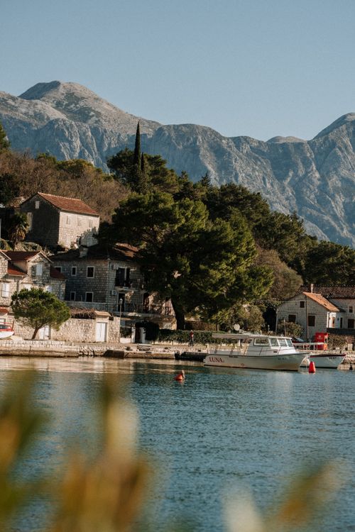 Scenic Coastal Village with Mountain Backdrop · Free Stock Photo