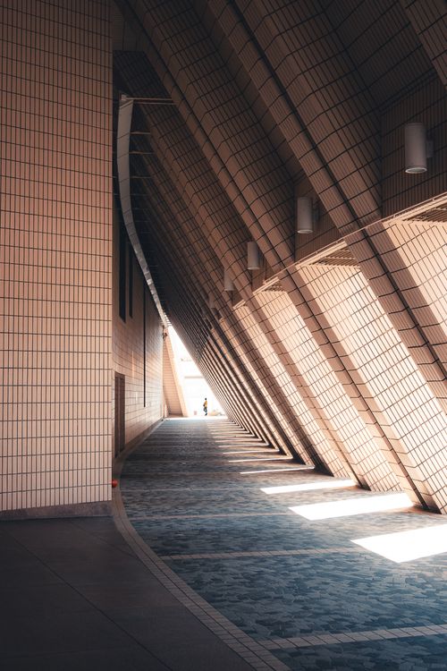 Free Dramatic light and shadow play in a Hong Kong architectural corridor. Stock Photo