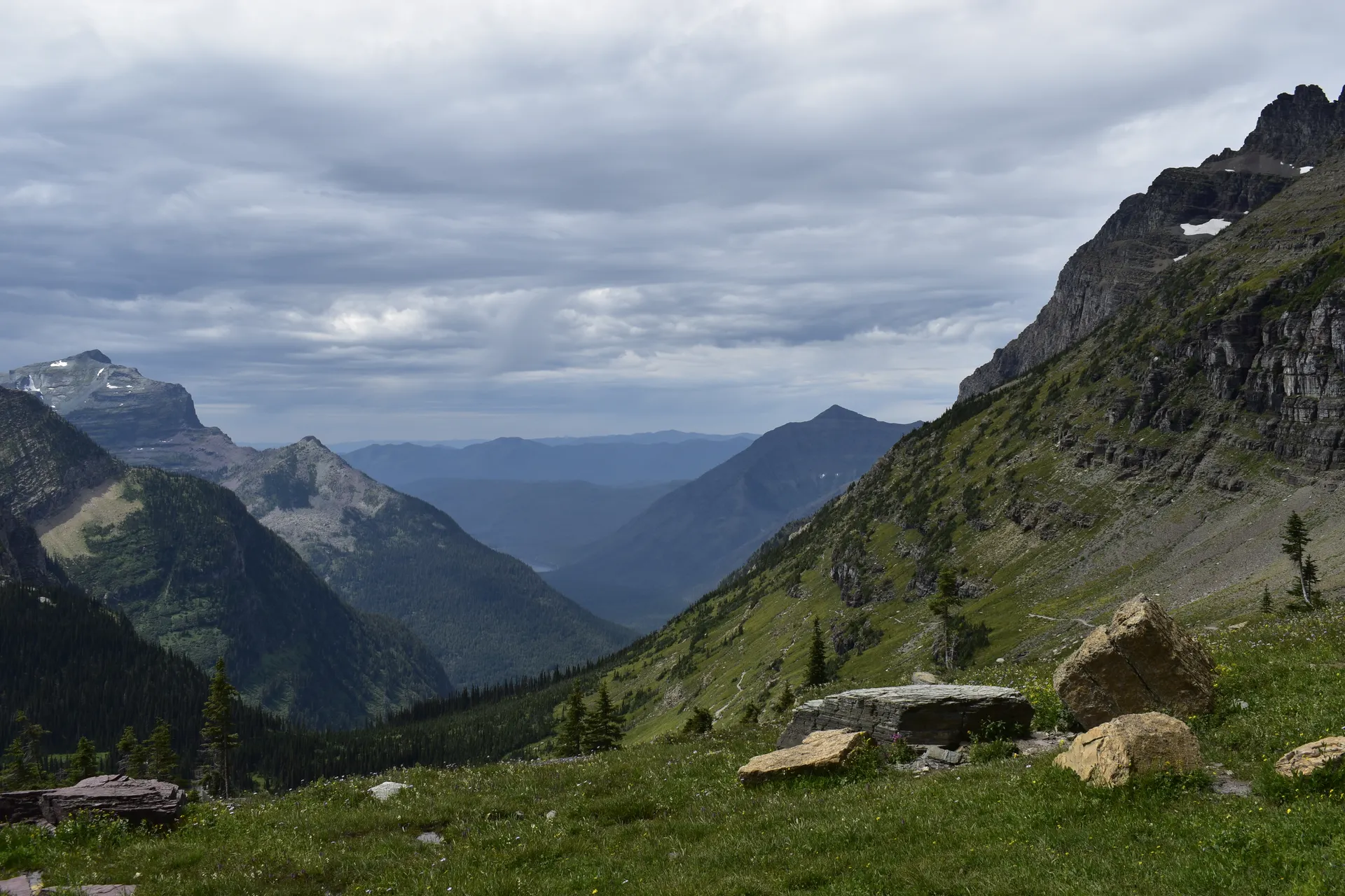 Vista of mountains and lush valleys in Glacier National Park, Montana captured on a cloudy summer day. Vista of mountains and lush valleys in Glacier National Park, Montana captured on a cloudy summer day.