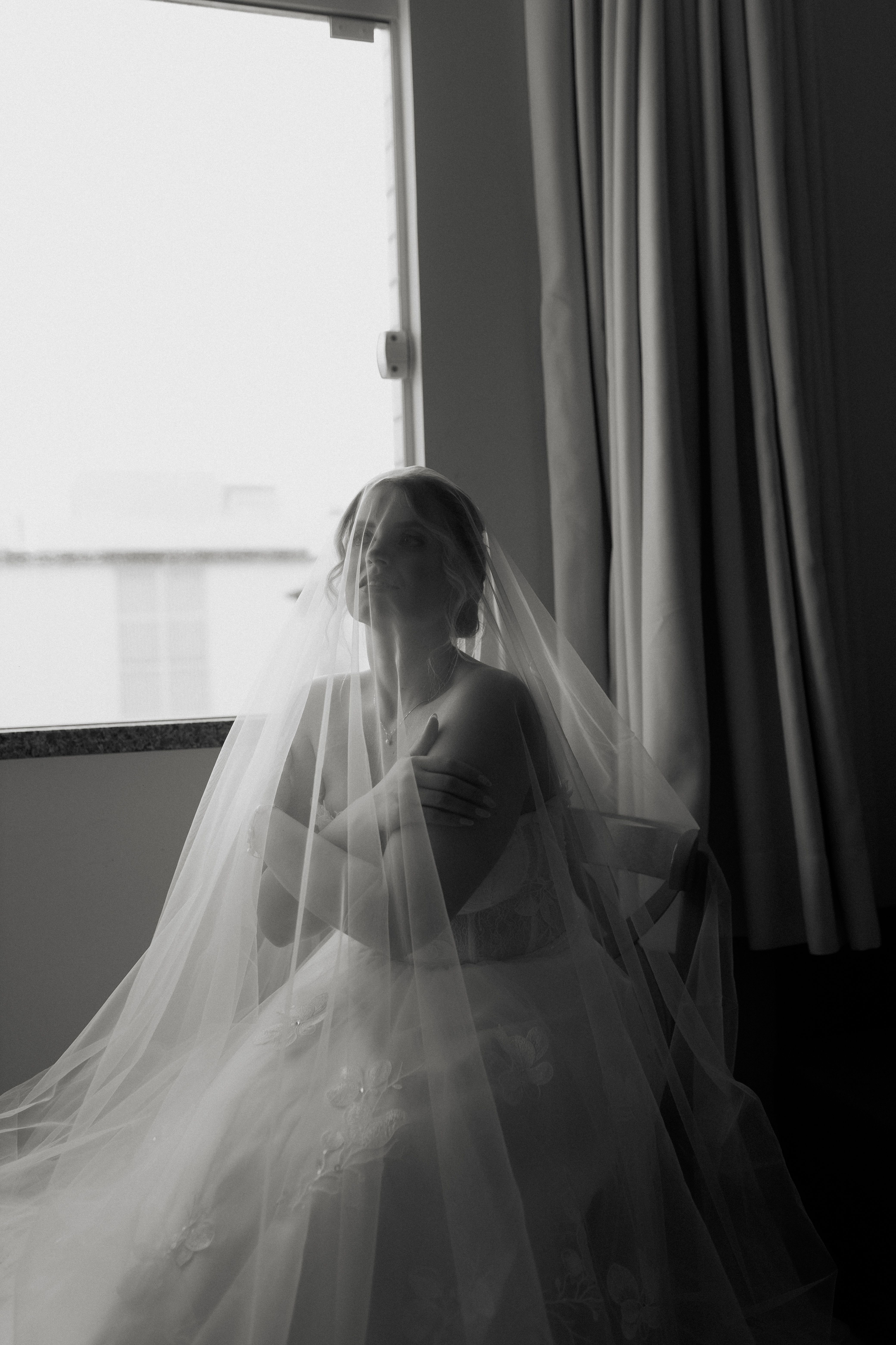 Bride in a veil photographed in soft window light