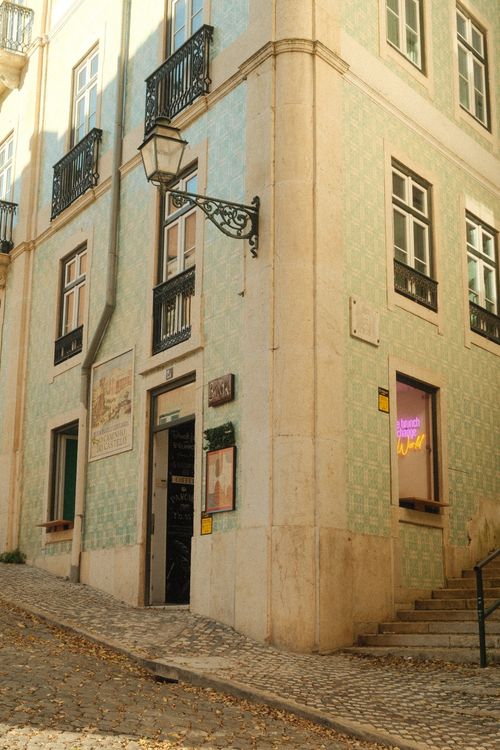Free A picturesque street in Lisbon showcasing traditional Portuguese tiles and architecture on a sunny day. Stock Photo