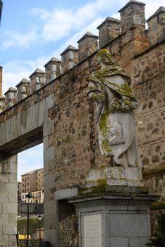 Stone statue and ancient wall in Toledo, Spain, showcasing medieval architecture.