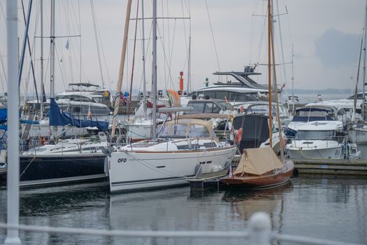 Vibrant marina scene in Gdańsk, Poland featuring multiple yachts and sailboats on a summer day.