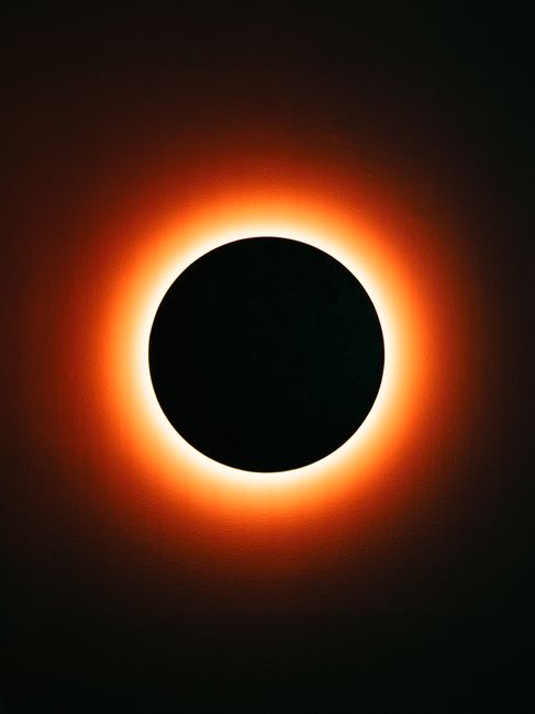 Dramatic view of a total solar eclipse showcasing a fiery ring illuminating the dark circle.