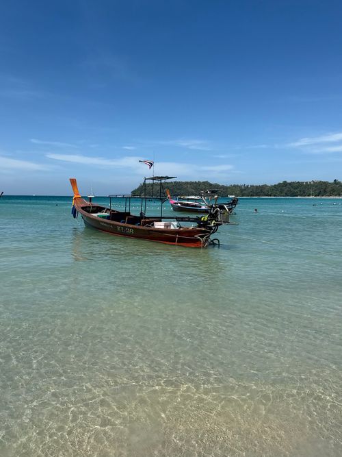 Free Serene view of longtail boats anchored in clear waters at Phuket, Thailand Stock Photo