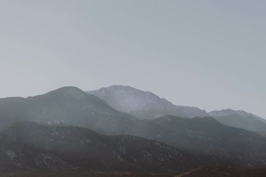 Scenic view of Pikes Peak with a misty atmosphere in Colorado Springs.