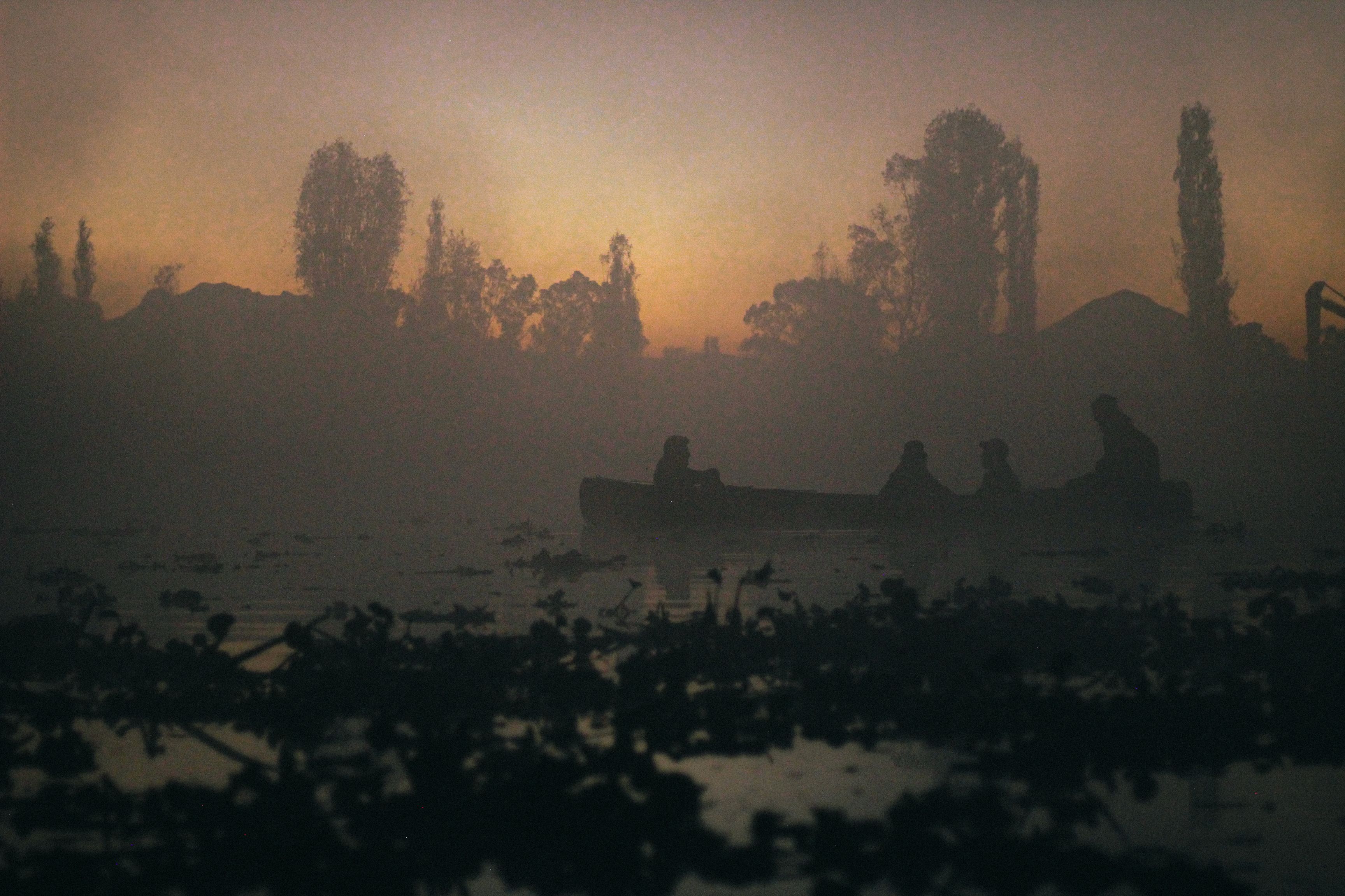Canoe silhouetted in fog at sunrise — photo by Didier Villafuerte Araoz on Pexels