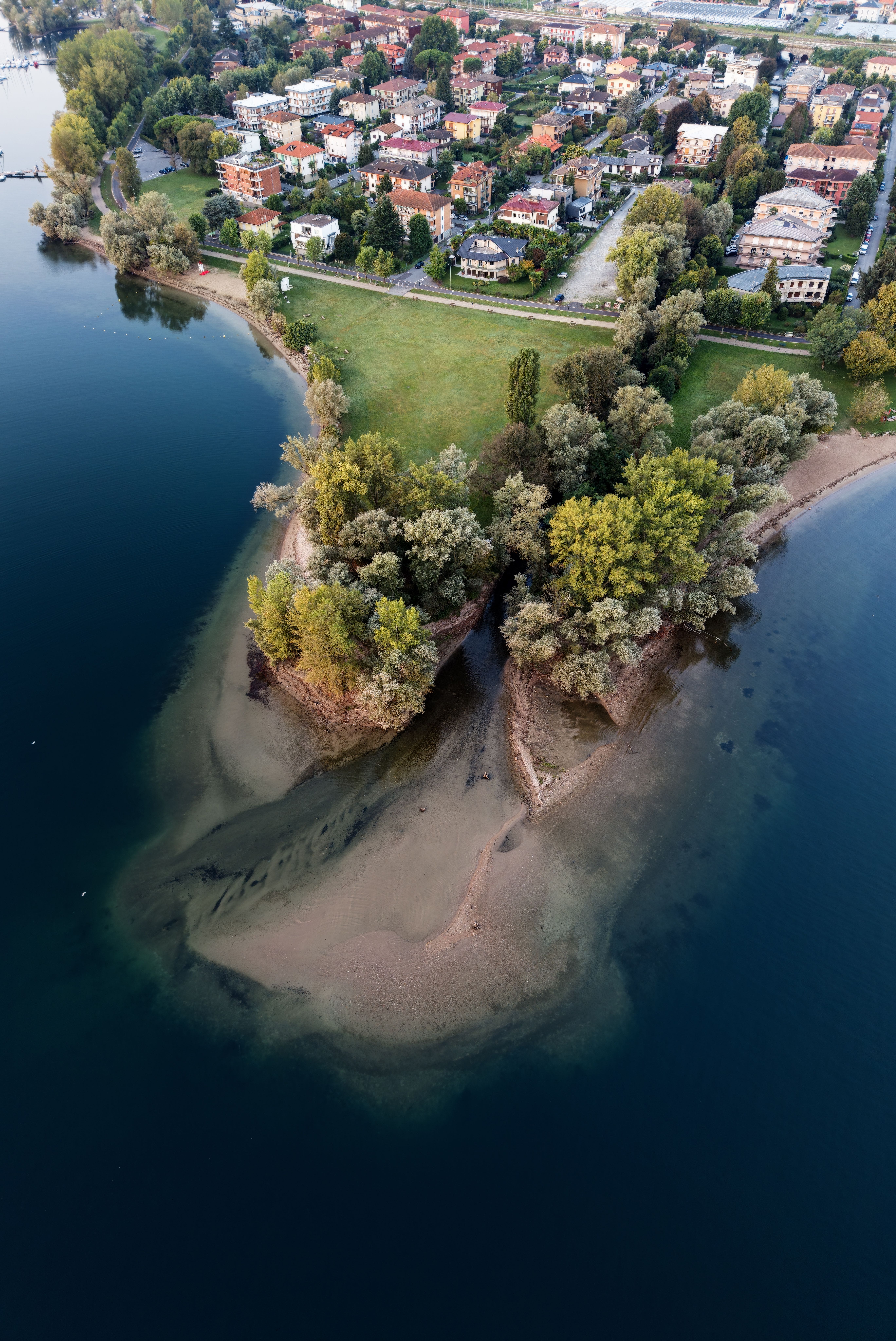 Stunning aerial shot of Rivera's scenic lakeside and residential area, showcasing lush greenery and tranquil water.