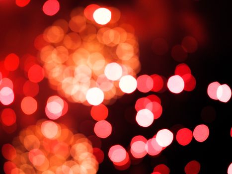 Abstract red and orange bokeh lights creating a vibrant and festive background.