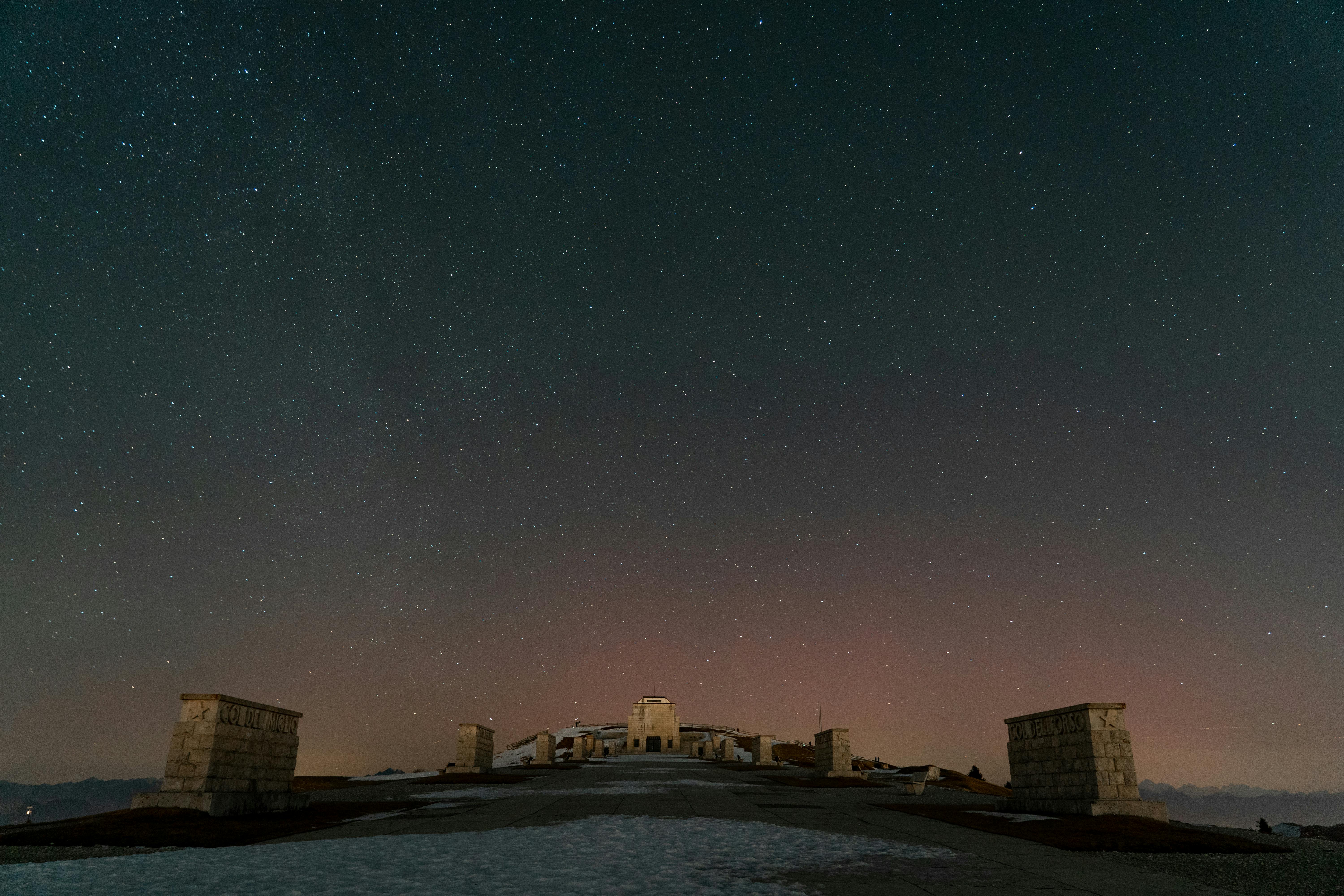 A stunning starry night view of the Monte Grappa War Memorial in Veneto, Italy.