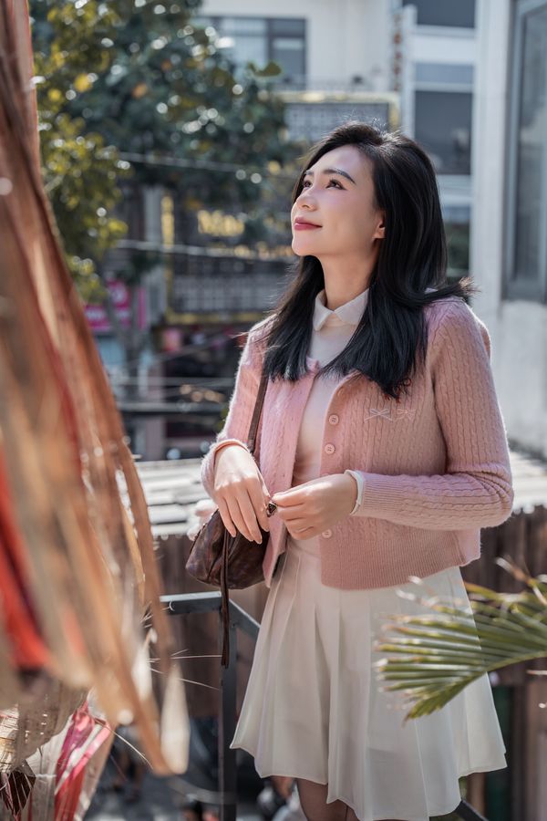 Woman in cardigan and skirt outfit