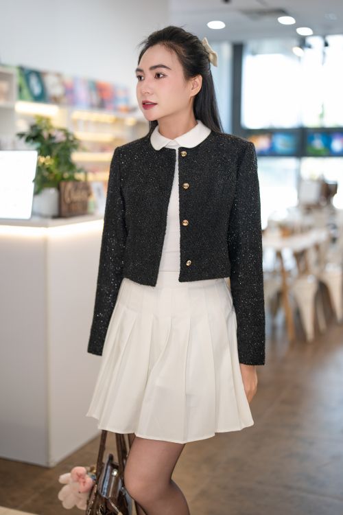 Woman in a classic tweed jacket with a midi skirt