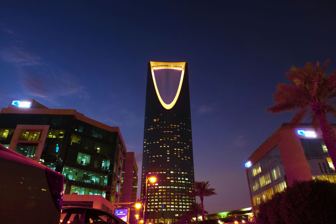 advertising agency saudi arabia - Bilingual campaign creatives on a laptop with Riyadh skyline in the background