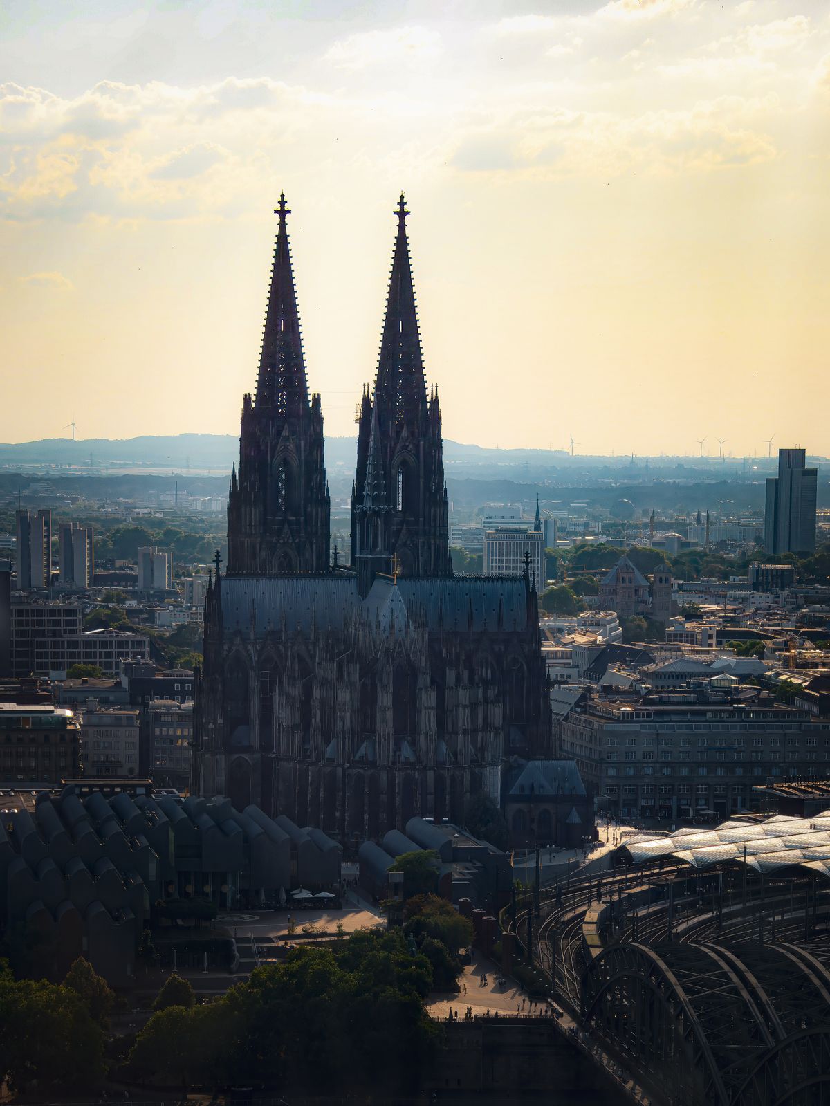 Aerial view of Cologne Cathedral's Gothic spires at sunset