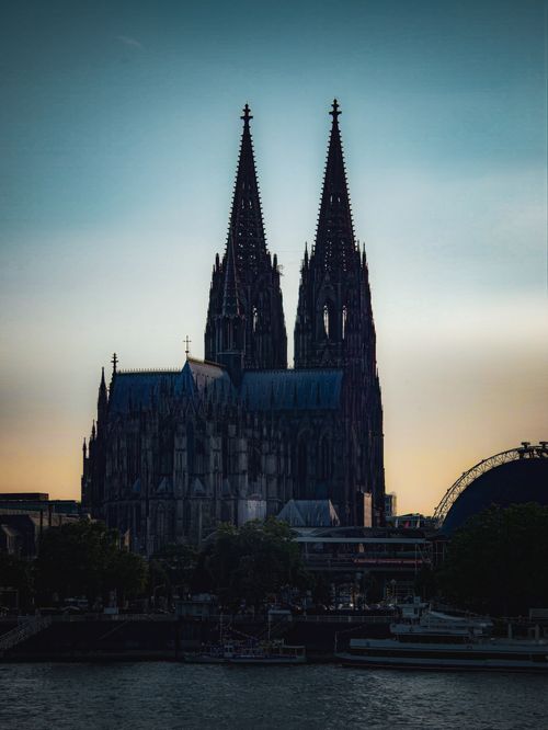 Free Majestic view of Cologne Cathedral silhouetted against a twilight sky, famous Gothic architecture in Germany. Stock Photo