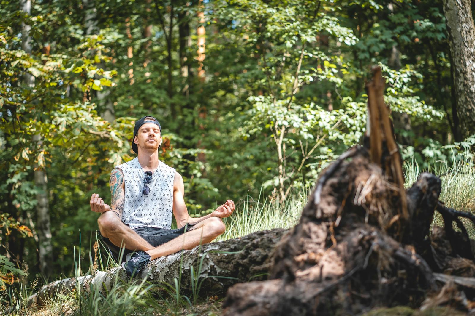 young gentleman meditating in the forest.