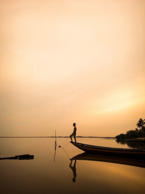 A Man Who's On The Wooden Boat