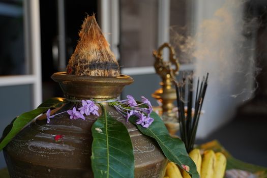 A beautiful arrangement for Pongal festival featuring a decorated pot, mango leaves, flowers, and bananas in Sri Lanka.