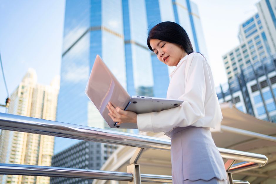 GILTI NCTI tax expat business owner abroad — businesswoman using laptop internationally