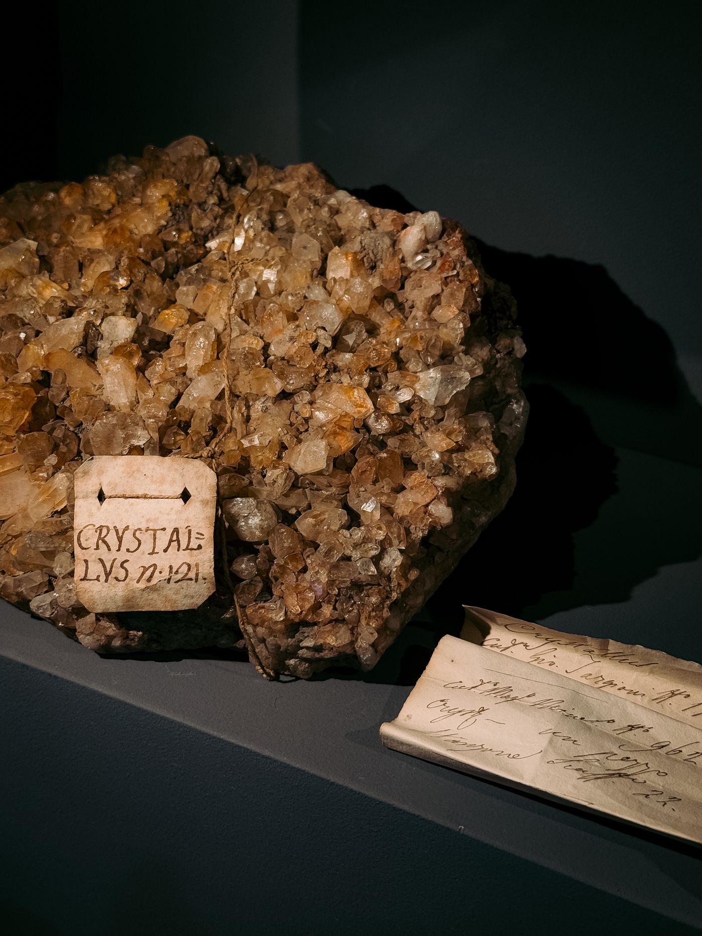 Mineral specimen displayed beside handwritten collection labels