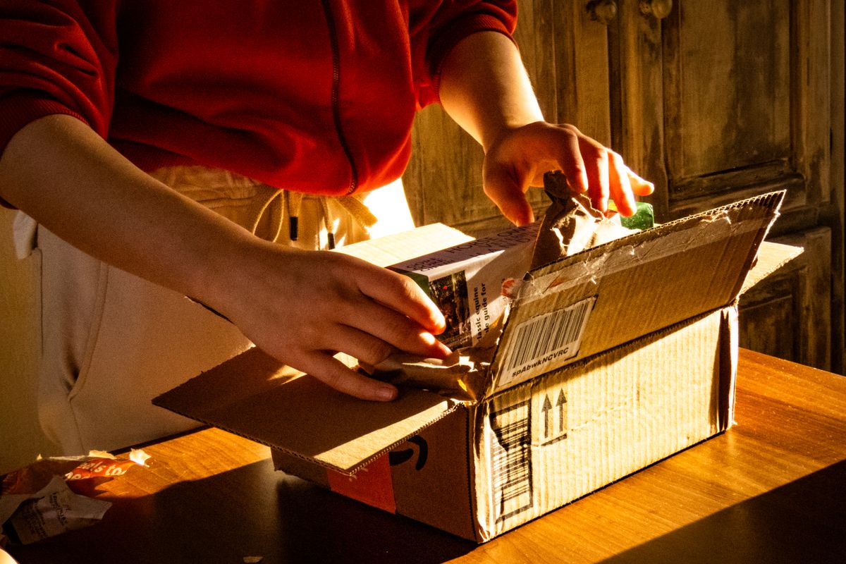 Unboxing a delivery parcel in warm light
