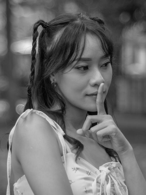 Free Elegant black and white portrait of a woman with braided hair in a contemplative pose. Stock Photo