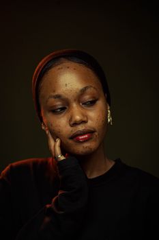 Close-up portrait of a woman with natural beauty, wearing minimal makeup and a peaceful expression.